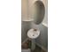 Stylish powder room featuring a pedestal sink, decorative mirror, and sleek fixtures at 3484 Enterkin Ln, South Fulton, GA 30349