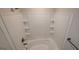 Clean and modern bathroom featuring a bathtub with white tiled surround and built-in shelving at 3484 Enterkin Ln, South Fulton, GA 30349