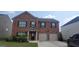 Charming two-story brick home with a well-manicured lawn and an attached two-car garage at 3484 Enterkin Ln, South Fulton, GA 30349