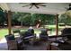 Cozy outdoor patio featuring comfortable seating, ceiling fans, and a clear view of the expansive backyard at 9 Warrior Way, Sharpsburg, GA 30277
