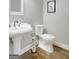A well-lit bathroom featuring a pedestal sink and classic fixtures, designed for functionality and style at 9 Warrior Way, Sharpsburg, GA 30277