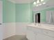 Bright bathroom with modern sink, white countertops, and mint green walls at 9 Warrior Way, Sharpsburg, GA 30277