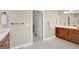 Bathroom featuring a double vanity with dark wood cabinets and tile floors at 9 Warrior Way, Sharpsburg, GA 30277