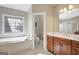 Bathroom with a standalone tub, walk-in shower, and double vanity with dark wood cabinets at 9 Warrior Way, Sharpsburg, GA 30277