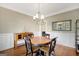 Bright dining room with hardwood floors, chandelier, wainscoting and ample natural light at 9 Warrior Way, Sharpsburg, GA 30277