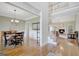 Open dining room with hardwood floors that flows into the living room with fireplace and stairway at 9 Warrior Way, Sharpsburg, GA 30277