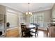 Elegant dining room with hardwood floors, traditional chandelier, and classic wainscoting at 9 Warrior Way, Sharpsburg, GA 30277