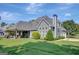 Charming home with a covered patio, lush landscaping, a basketball hoop and an attached garage at 9 Warrior Way, Sharpsburg, GA 30277