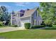 Charming two-story home featuring a white garage door, lush lawn and a basketball hoop at 9 Warrior Way, Sharpsburg, GA 30277