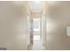 Hallway with neutral walls and views into the bathroom with a standalone tub at 9 Warrior Way, Sharpsburg, GA 30277
