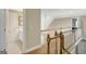 Upstairs hallway overlooking the stairs and a view into a bathroom at 9 Warrior Way, Sharpsburg, GA 30277