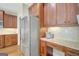 Kitchen featuring stainless steel refrigerator, granite countertop and cherry wood cabinets at 9 Warrior Way, Sharpsburg, GA 30277