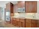 Kitchen features stainless steel appliances, wood cabinets, granite countertops and backsplash at 9 Warrior Way, Sharpsburg, GA 30277