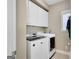 Well-equipped laundry room showcasing modern washer and dryer units, as well as ample cabinet space at 9 Warrior Way, Sharpsburg, GA 30277