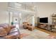 Spacious living room with a fireplace, hardwood floors and an open view of the staircase at 9 Warrior Way, Sharpsburg, GA 30277