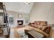 Comfortable living room boasts a brick fireplace, large windows, and hardwood floors at 9 Warrior Way, Sharpsburg, GA 30277