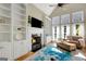 Bright living room with fireplace, built-ins and large windows at 9 Warrior Way, Sharpsburg, GA 30277