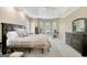 Spacious main bedroom with a large bed, arched windows, and an exercise bike at 9 Warrior Way, Sharpsburg, GA 30277