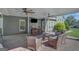 Relaxing covered patio includes ceiling fans, bar area with seating, and cozy wicker furniture at 9 Warrior Way, Sharpsburg, GA 30277