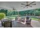 Enjoy the outdoors in this spacious covered patio with ceiling fans and outdoor furniture at 9 Warrior Way, Sharpsburg, GA 30277