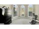 Sitting room featuring three arched windows, neutral carpet, and a black dresser at 9 Warrior Way, Sharpsburg, GA 30277