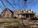 Charming brick home featuring dormer windows and a covered front porch for relaxing outdoor living at 291 Morgan Mill Rd, Brooks, GA 30205
