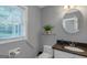 Bright half-bathroom featuring granite countertops, modern fixtures and natural light at 308 Larkspur Turn, Peachtree City, GA 30269