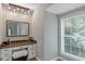 Charming vanity with granite countertops, ample storage, and bright natural light from the adjacent window at 308 Larkspur Turn, Peachtree City, GA 30269