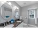 Bathroom with dual sinks, granite countertops, updated fixtures, and lots of natural light at 308 Larkspur Turn, Peachtree City, GA 30269