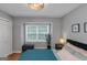 Serene bedroom featuring a comfortable bed, side tables, and a bright window with natural light at 308 Larkspur Turn, Peachtree City, GA 30269
