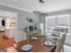 Elegant dining room with long wood table, modern lighting, and open view to kitchen, perfect for gatherings at 308 Larkspur Turn, Peachtree City, GA 30269