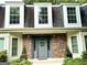 Close-up view of the front entrance with brick accents and a decorative door at 308 Larkspur Turn, Peachtree City, GA 30269