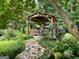 Beautiful gazebo surrounded by lush landscaping and a stone creek bed at 308 Larkspur Turn, Peachtree City, GA 30269