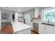 Bright kitchen featuring white cabinets, an island, and stainless steel appliances for a modern cooking experience at 308 Larkspur Turn, Peachtree City, GA 30269