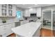 Modern kitchen with white cabinets, stainless steel appliances, and a large island at 308 Larkspur Turn, Peachtree City, GA 30269