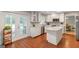 Beautiful kitchen featuring white cabinetry, an island, stainless appliances, and hardwood floors at 308 Larkspur Turn, Peachtree City, GA 30269