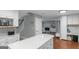 Modern kitchen with white cabinets, quartz countertop island, and open view to the Gathering room, perfect for entertaining at 308 Larkspur Turn, Peachtree City, GA 30269