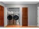 Convenient laundry room with modern side by side washer and dryer, and ample storage at 308 Larkspur Turn, Peachtree City, GA 30269