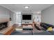 Inviting living room featuring a fireplace, large TV, and views to other rooms at 308 Larkspur Turn, Peachtree City, GA 30269