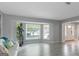Bright living room featuring a bay window, tile floors, statue, and modern decor, enhancing the inviting space at 308 Larkspur Turn, Peachtree City, GA 30269