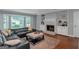 Cozy living room featuring a fireplace, built-in shelving, a bay window and hardwood floors at 308 Larkspur Turn, Peachtree City, GA 30269