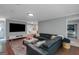 Bright living room with hardwood floors, built-in shelving, and large sectional at 308 Larkspur Turn, Peachtree City, GA 30269