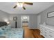 Bright bedroom with hardwood floors and an en suite bathroom with granite countertops at 308 Larkspur Turn, Peachtree City, GA 30269