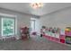 Spacious play room with natural light, dollhouse, table, and toy storage for organized play area at 308 Larkspur Turn, Peachtree City, GA 30269