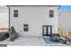 White two-story house featuring a concrete patio with patio furniture, offering a space for outdoor relaxation at 12167 Conrad Cir, Hampton, GA 30228