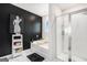 Modern bathroom features a soaking tub, glass shower, and sleek black and white accents at 12167 Conrad Cir, Hampton, GA 30228