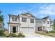 Charming two-story home with an attached garage, landscaped yard, and neutral exterior at 12167 Conrad Cir, Hampton, GA 30228