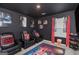Home theater with black walls, movie posters, recliners, and curtains at 12167 Conrad Cir, Hampton, GA 30228