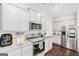 Well-equipped kitchen featuring modern appliances, granite countertops, and white cabinetry at 12167 Conrad Cir, Hampton, GA 30228