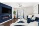 Comfortable living room featuring a sleek fireplace, modern ceiling fan, and lots of natural light at 12167 Conrad Cir, Hampton, GA 30228
